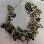 HEAVY SIL CHARM BRACELET WITH APPROX 36 CHARMS, 88g