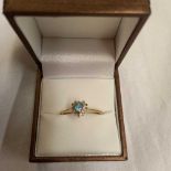 A 9ct RING WITH AQUAMARINE COLOUR HEART SHAPED CENTRE STONE (SOME BOARDER STONES MISSING)