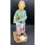 SMALL CHINA FIGURE OF A CHINAMAN WITH OPIUM PIPE WITH LONG PLATTED HAIR, THE BASE WITH VINTAGE