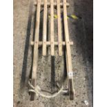WOODEN SLEDGE WITH METAL RUNNERS APPROX 36'' LONG MARKED DAVOS