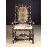 A Charles II Caned Walnut Armchair.