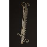 A 18th Century Style Wrought Iron Trammel Hook with scroll terminals.