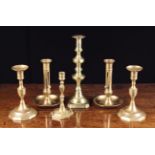 Six 19th Century Brass Candlesticks: A pair with sliding height adjusters and round dished bases 19