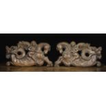 A Pair of 17th Century Pierced & Carved Oak Panels depicting winged cherubs riding on the backs of
