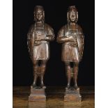 A Pair of 19th Century Figural Carved Supports in the form of soldiers wearing helmets and tunics,
