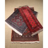 Three Small Carpet Rugs: One woven with two rows of seven terracotta ground octagonal panels in