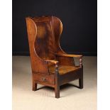 A 19th Century Low Country Armchair with side drawer.