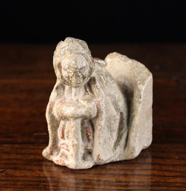 A Small Carved Stone Figure with residual polychrome, 15th century, 10 cm high, 8 cm wide,