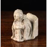 A Small Carved Stone Figure with residual polychrome, 15th century, 10 cm high, 8 cm wide,