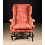 An 18th Century Upholstered Wing Armchair recovered in a terracotta linen type fabric woven with