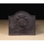 A Cast Iron Fire Back with break-arched top above a crowned armorial crest, 48 cm high,