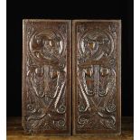 A Pair of Fabulous 16th Century Finely Carved Oak Panels depicting profiled male heads with long