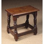 A 19th Century Oak Joint Stool having a moulded top on groove turned baluster legs united by