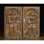 A Pair of 16th Century Oak Reliefs depicting figures stood beneath arches 31.