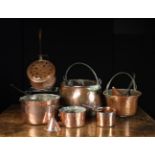 A Group of Antique Copper Kitchenware: A large oval pan with rolled rim and iron swing handle on