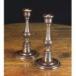 A Pair of 19th Century Turned Lignum Candlesticks.