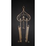 A Pair of 17th Century Style Trammel hooks hanging from a decorative wrought iron rack ornamented