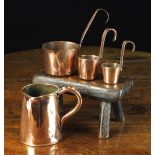 Four Copper Measures comprising of an 18th century sheet copper jug having a rolled rim with side