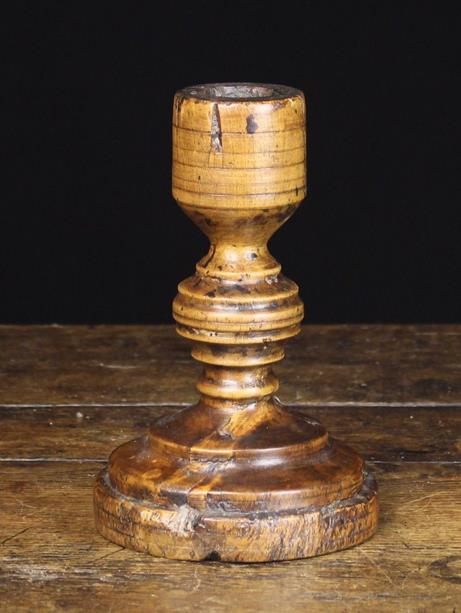 An 18th Century French Turned Treen Candlestick with ringed bulbous stem on a round moulded foot,
