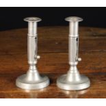A Pair of Pewter Candlesticks with push up slides to the octagonal stems,