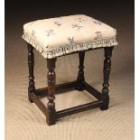 A 17th Century Oak Stool with Upholstered Seat covered in a finely ribbed cream fabric embroidered