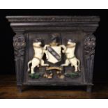 A Carved & Polychrome Painted Armorial Crest featuring two rampant bulls flanking an argent shield