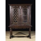 A Glazed Oak Cabinet on Stand with shelved interior.