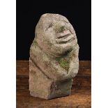 A Stone Corbel carved in the form of a head, approx 20 cm high, 20 cm wide,