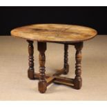 A 17th/18th Century Continental Oak Fold-over Demi-lune Table standing on three multi-baluster