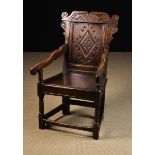 A 17th Century & Later Joined Oak Dales Wainscot Chair having a carved cresting rail with voluted