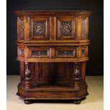 A 16th Century Carved Walnut Dressoir of Canted Form.