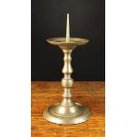 A 16th Century Style French Bronze Pricket Candlestick having a knopped stem on a turned spreading