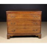 An 18th Century Oak Chest of three long, wide drawers with lip-moulded edges,