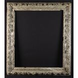 A 17th Century Carved & Silvered Wooden Picture Frame adorned with clusters of leaves,