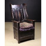 An 18th Century Joined Fruitwood Enclosed Wing Armchair with residual paint.