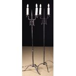 A Pair of Wrought Iron Twin-Branch Standard Lamps with electric 'candle' lights,