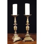 A Pair of 18th Century Style Flemish Pricket Candlesticks with flared drip pans above knopped stems