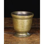 An Antique Bronze Mortar with a raised rim band and and flared foot, 4" (10 cm) high,
