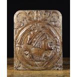 A 16th Century Carved Oak Romayne Panel depicting the profiled head of a merchant within a roundel