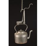 An 18th Century Wrought Iron Kettle Tilt and a 19th Century 4 Quart Cast Iron Kettle.