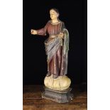 An Antique Naively Carved & Painted Wooden Figure of a female saint wearing a blue cloak draped