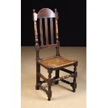 A Late 17th/Early 18th Century Joined Oak Slat Back Side Chair with an arched top rail above three