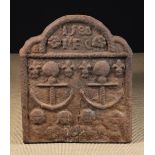 An Elizabethan Cast Iron Fireback dated 1588 above initials IFC and two anchors with coiled ropes