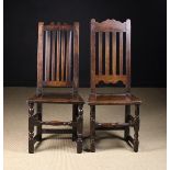 Two Early 18th Century Joined Oak Slat Back Side Chairs with shaped cresting rails and plank seats