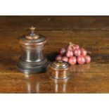 Two 19th Century Turned Treen Lidded Pots. One surmounted by an urn finial 13 cm high, 9.