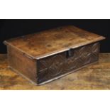 A 16th Century Boarded Oak Box with compass work and stylised flower carved decoration to the front