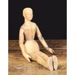 A Small Late 19th Century Treen Lay Figure carved from pine, with articulated limbs, detailed face,