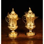 A Pair of Antique Italian Silver Gilt Aqua Vino Cruets embossed and chased with elaborate