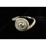 A Diamond Ring set with a .54 carat round brilliant cut stone surrounded by 0.