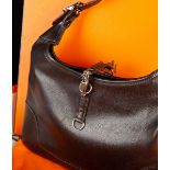 A Hermès Trim Handbag of very dark brown leather with gold coloured metal fittings,